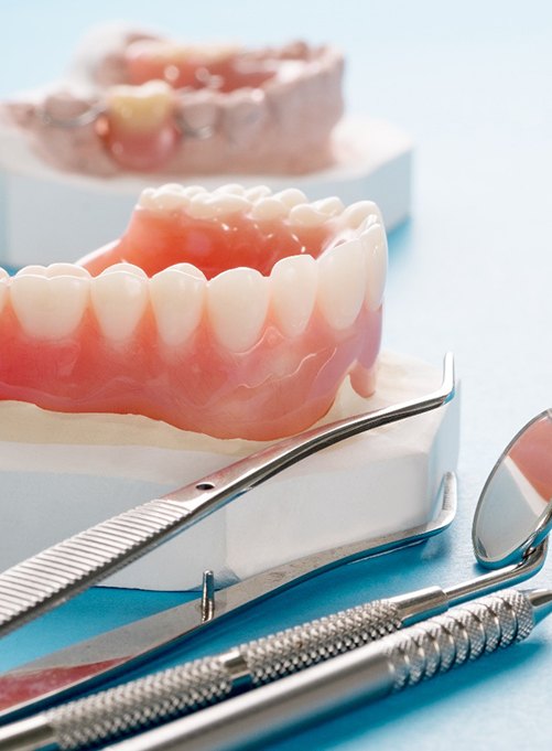 Closeup of dentures in Rockwall and dental tools
