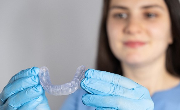 Dental team member wearing a nightguard for bruxism