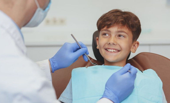 Young boy smiling at his dentist