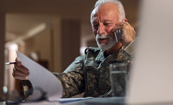 Senior veteran making a phone call