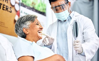 Dentist showing patient their smile in reflection