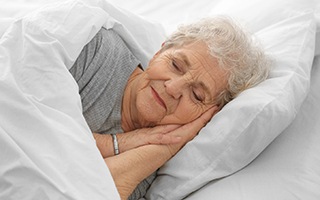 Close-up of senior woman sleeping in bed