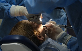 Dentist performing surgery