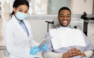 Man and dentist smiling before treatment