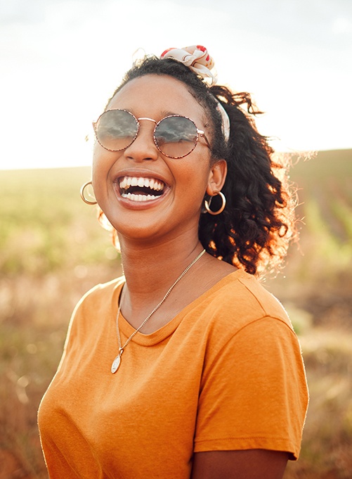 Happy, smiling woman standing outside