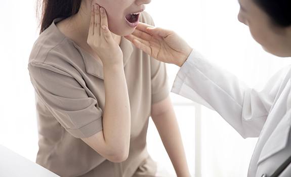 Dentist performing TMJ examination