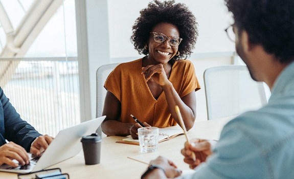 Woman smiling at colleague in office